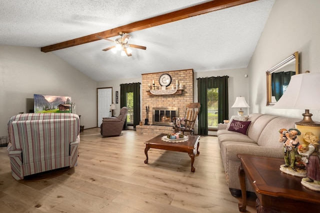 213 Cobb St, Corrigan, TX 75939 - living area with wood finished floors, ceiling fan, a textured ceiling, and a brick fireplace