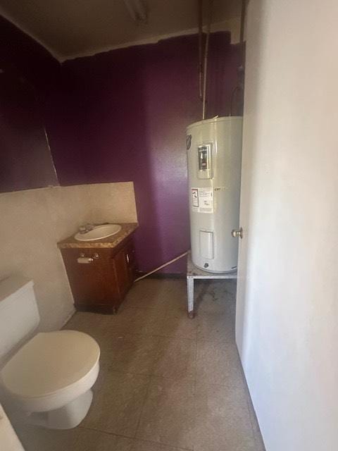 8008 De Priest St, Houston, TX 77088 - bathroom featuring water heater and toilet