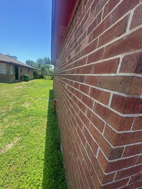 8008 De Priest St, Houston, TX 77088 - view of side of home with brick siding and a yard