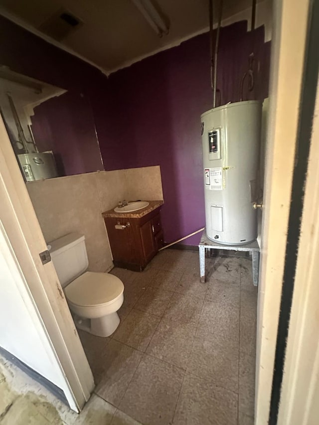 8008 De Priest St, Houston, TX 77088 - bathroom with water heater, toilet, and vanity