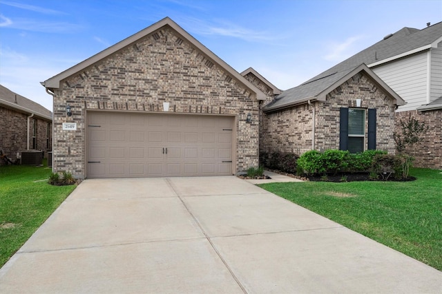 25419 Whitehaven Gate St, Katy, TX 77493 - view of front of home with driveway, a front yard, a garage, central AC, and brick siding
