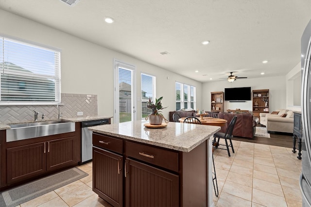 25419 Whitehaven Gate St, Katy, TX 77493 - kitchen featuring stainless steel dishwasher, a sink, a ceiling fan, light tile patterned floors, and recessed lighting