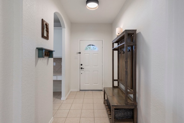 6103 Moran Crest Dr, Spring, TX 77388 - entryway featuring light tile patterned floors, arched walkways, baseboards, and a textured wall