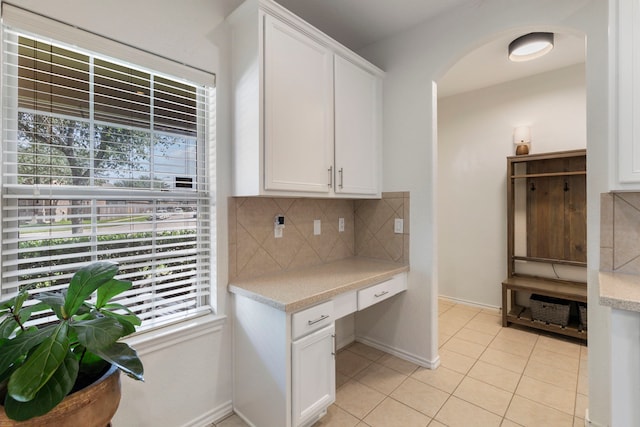 6103 Moran Crest Dr, Spring, TX 77388 - kitchen with backsplash, arched walkways, healthy amount of natural light, and white cabinets