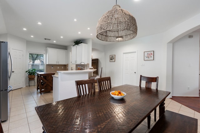 6103 Moran Crest Dr, Spring, TX 77388 - dining area featuring arched walkways, light tile patterned floors, a chandelier, and recessed lighting