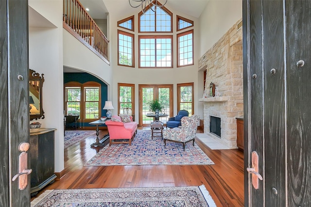 5318 Westerham St, Fulshear, TX 77441 - living room with wood finished floors, a stone fireplace, and high vaulted ceiling