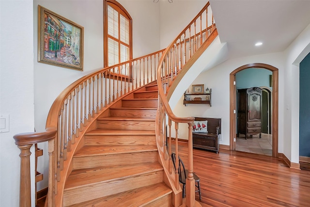 5318 Westerham St, Fulshear, TX 77441 - staircase with arched walkways, wood finished floors, recessed lighting, and baseboards