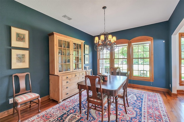 5318 Westerham St, Fulshear, TX 77441 - dining space featuring wood finished floors, a chandelier, and baseboards