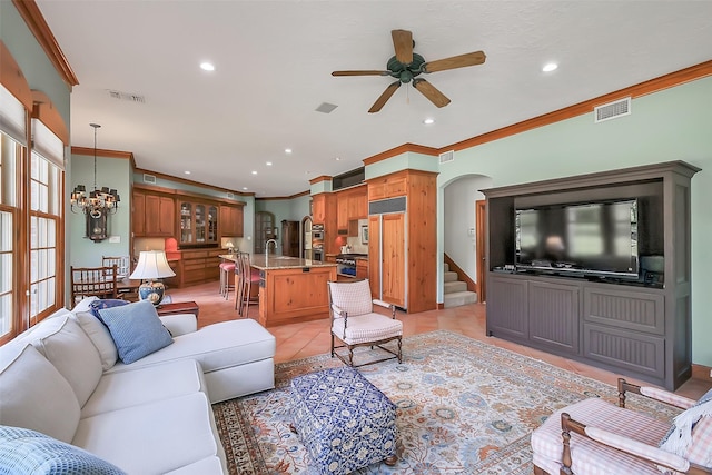 5318 Westerham St, Fulshear, TX 77441 - living room featuring arched walkways, ceiling fan, a chandelier, crown molding, and recessed lighting