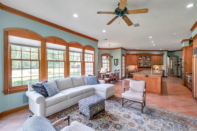 5318 Westerham St, Fulshear, TX 77441 - living room featuring light tile patterned floors, arched walkways, ornamental molding, recessed lighting, and a ceiling fan