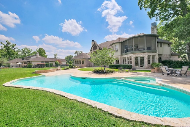 5318 Westerham St, Fulshear, TX 77441 - outdoor pool with a lawn, a patio area, an in-ground hot tub, and a sunroom