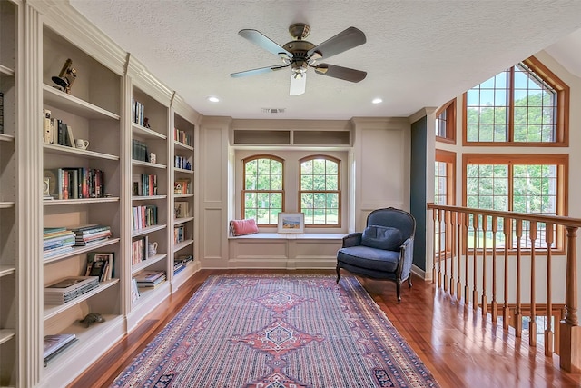 5318 Westerham St, Fulshear, TX 77441 - living area with wood finished floors, ceiling fan, a textured ceiling, and recessed lighting