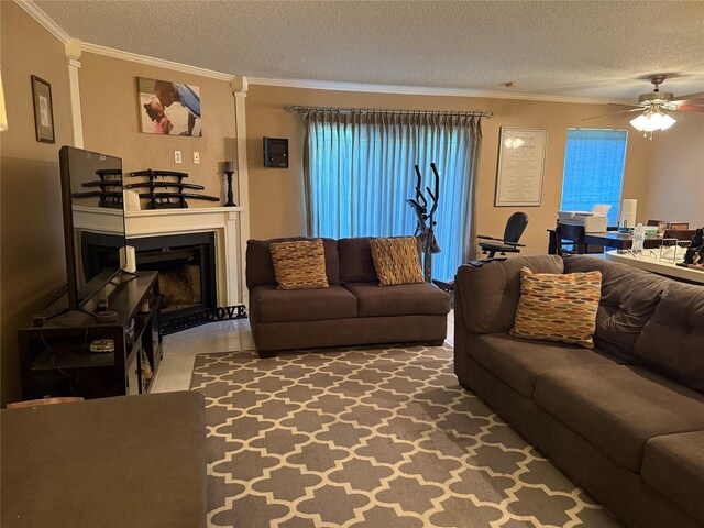 2120 El Paseo St Unit 209, Houston, TX 77054 - living area with a textured ceiling, a ceiling fan, ornamental molding, and a glass covered fireplace