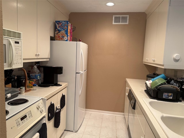 2120 El Paseo St Unit 209, Houston, TX 77054 - kitchen with white appliances, light countertops, baseboards, white cabinets, and a sink