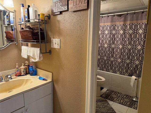 2120 El Paseo St Unit 209, Houston, TX 77054 - full bathroom featuring vanity, tile patterned flooring, toilet, a textured wall, and shower / tub combo with curtain