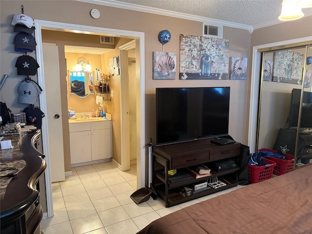 2120 El Paseo St Unit 209, Houston, TX 77054 - bedroom with light tile patterned floors, crown molding, and a textured ceiling