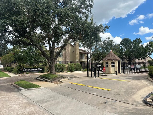 2120 El Paseo St Unit 209, Houston, TX 77054 - view of concrete road featuring traffic signs, a gated entry, and curbs