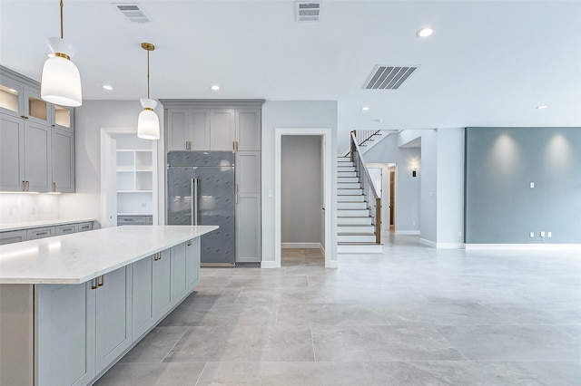 6522 Westview Dr, Houston, TX 77055 - kitchen with gray cabinetry, light countertops, a center island, baseboards, and recessed lighting