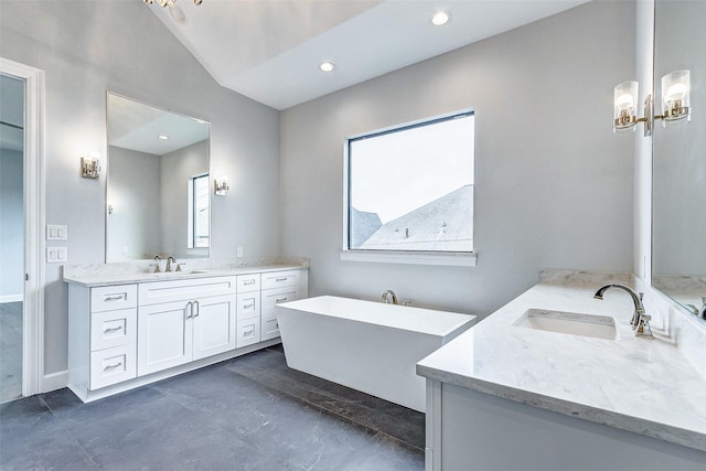 6522 Westview Dr, Houston, TX 77055 - bathroom featuring two vanities, a freestanding bath, recessed lighting, and baseboards