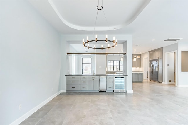 6522 Westview Dr, Houston, TX 77055 - unfurnished dining area with beverage cooler, a chandelier, baseboards, and a sink