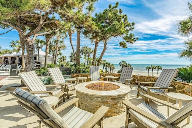 5220 Seawall Blvd Unit 1035, Galveston, TX 77551 - view of patio featuring a water view and a fire pit