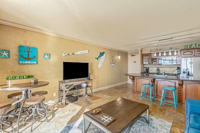 5220 Seawall Blvd Unit 1035, Galveston, TX 77551 - living room with ornamental molding and light stone finish floors