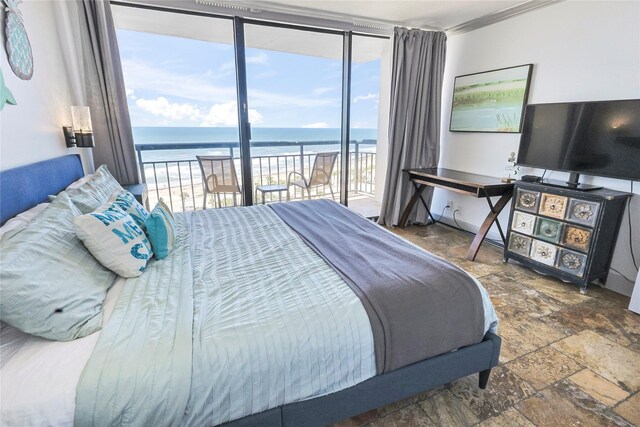 5220 Seawall Blvd Unit 1035, Galveston, TX 77551 - bedroom with multiple windows, access to exterior, stone tile floors, crown molding, and a wall of windows