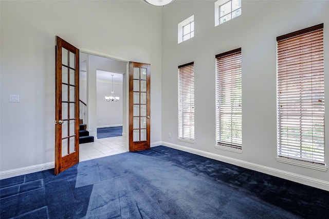22110 Stone Cross Ct, Katy, TX 77450 - empty room with french doors, carpet flooring, a chandelier, baseboards, and stairway