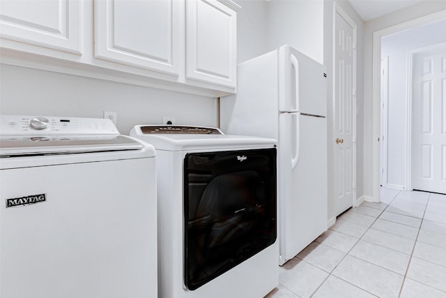 22110 Stone Cross Ct, Katy, TX 77450 - laundry area featuring washer and dryer, light tile patterned floors, and cabinet space