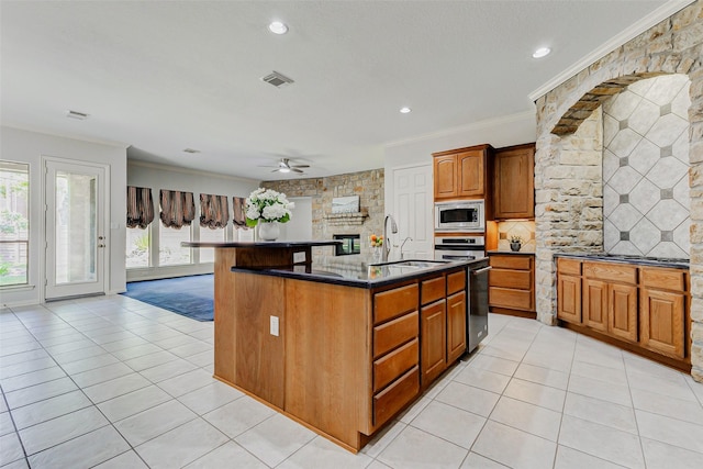 22110 Stone Cross Ct, Katy, TX 77450 - kitchen featuring stainless steel appliances, ornamental molding, light tile patterned floors, a ceiling fan, and an island with sink