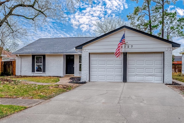 23227 Pine Post Ln, Spring, TX 77373 - ranch-style house featuring driveway, a garage, brick siding, and a shingled roof