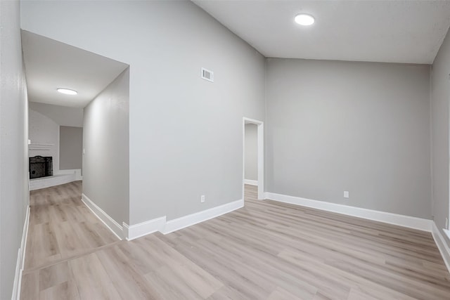 23227 Pine Post Ln, Spring, TX 77373 - spare room with light wood-style flooring, baseboards, and a brick fireplace
