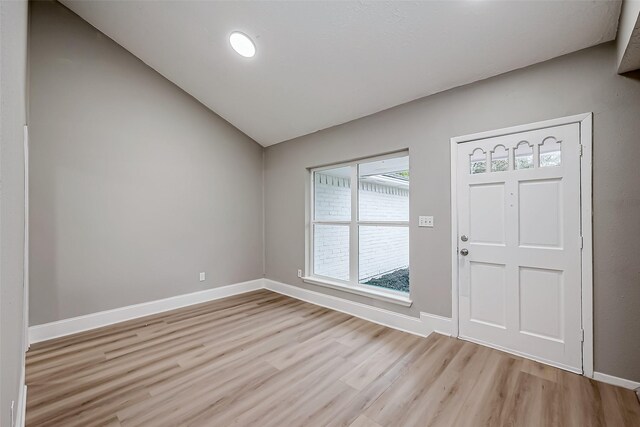 23227 Pine Post Ln, Spring, TX 77373 - foyer entrance featuring light wood-style flooring, lofted ceiling, and baseboards
