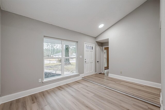 23227 Pine Post Ln, Spring, TX 77373 - empty room featuring lofted ceiling, light wood-type flooring, and baseboards