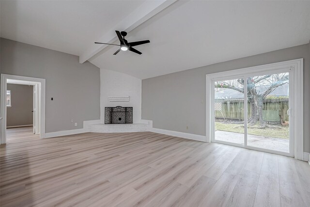 23227 Pine Post Ln, Spring, TX 77373 - unfurnished living room with a ceiling fan, light wood-style floors, baseboards, and a brick fireplace