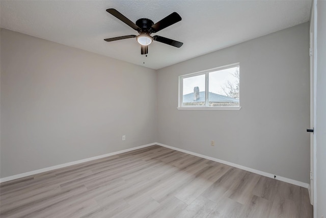 23227 Pine Post Ln, Spring, TX 77373 - spare room featuring light wood-style floors, a ceiling fan, and baseboards
