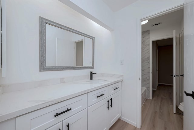23227 Pine Post Ln, Spring, TX 77373 - full bathroom with vanity, wood finished floors, a bathtub, and toilet