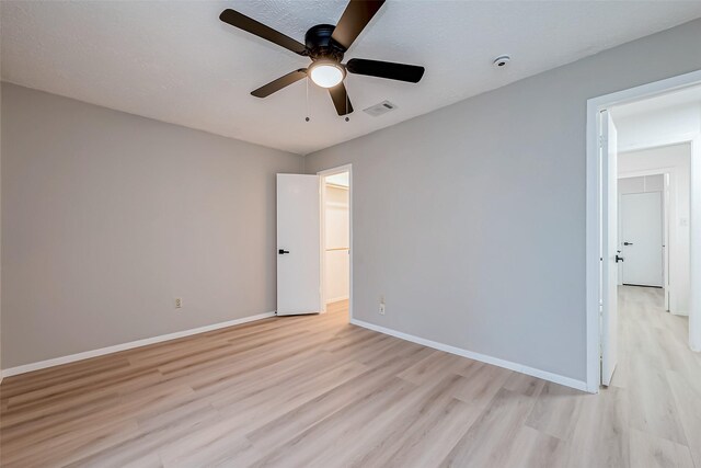 23227 Pine Post Ln, Spring, TX 77373 - spare room with light wood-type flooring, a ceiling fan, and baseboards