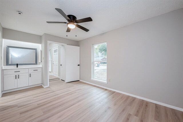 23227 Pine Post Ln, Spring, TX 77373 - unfurnished bedroom with light wood-type flooring, baseboards, ensuite bath, and a ceiling fan