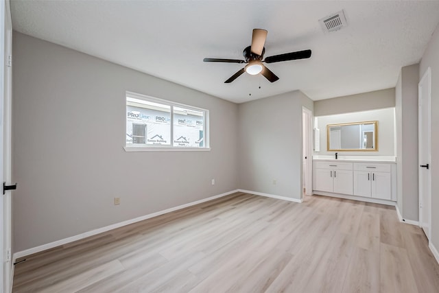 23227 Pine Post Ln, Spring, TX 77373 - unfurnished bedroom featuring light wood-type flooring, baseboards, connected bathroom, a ceiling fan, and a sink