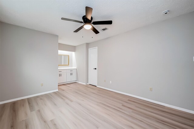 23227 Pine Post Ln, Spring, TX 77373 - empty room with light wood-style flooring, a ceiling fan, baseboards, a textured ceiling, and a smoke detector