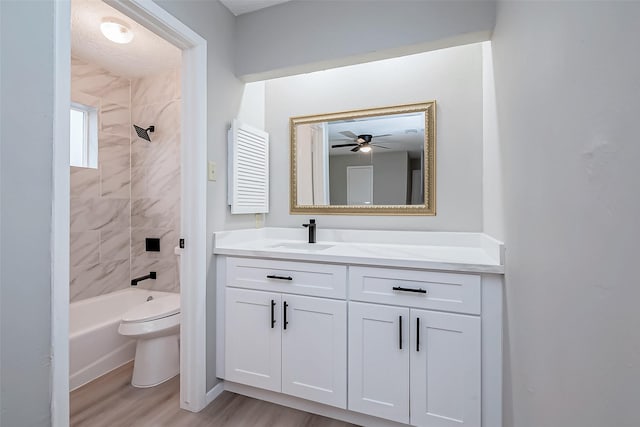 23227 Pine Post Ln, Spring, TX 77373 - full bathroom featuring toilet, vanity, wood finished floors, ceiling fan, and bathtub / shower combination