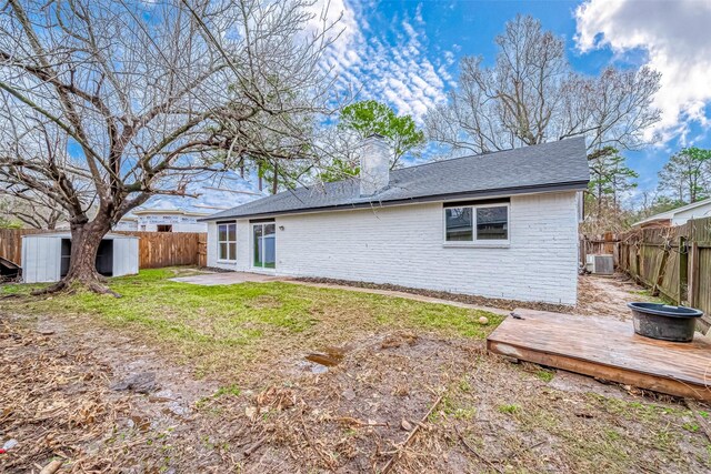 23227 Pine Post Ln, Spring, TX 77373 - rear view of property featuring a fenced backyard, a chimney, and brick siding