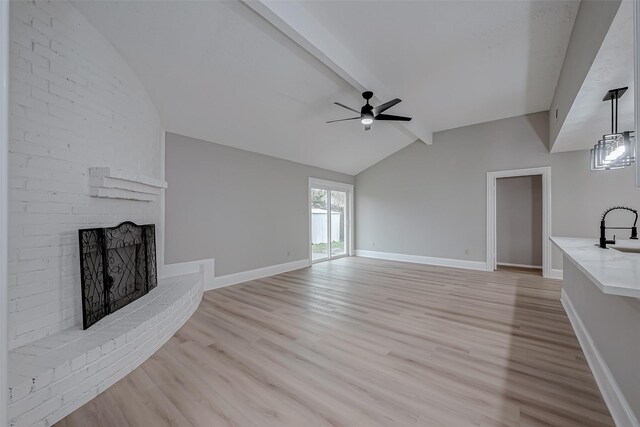 23227 Pine Post Ln, Spring, TX 77373 - unfurnished living room featuring a sink, ceiling fan, light wood-style flooring, a fireplace, and baseboards