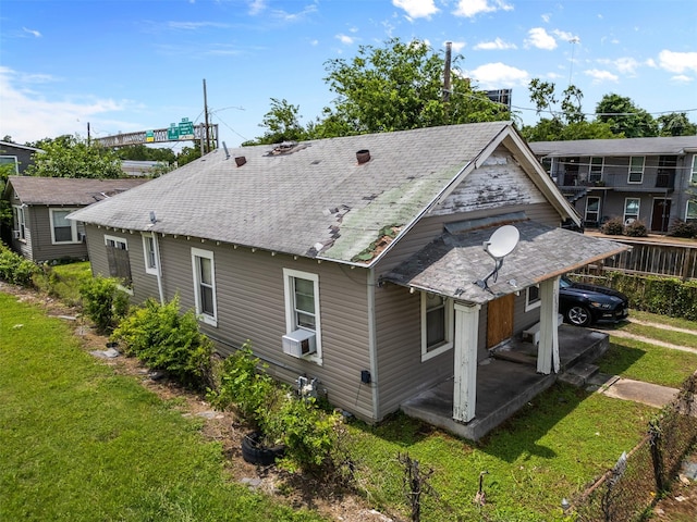 2007 Massie St, Houston, TX 77026 - back of property with a shingled roof, a yard, and cooling unit