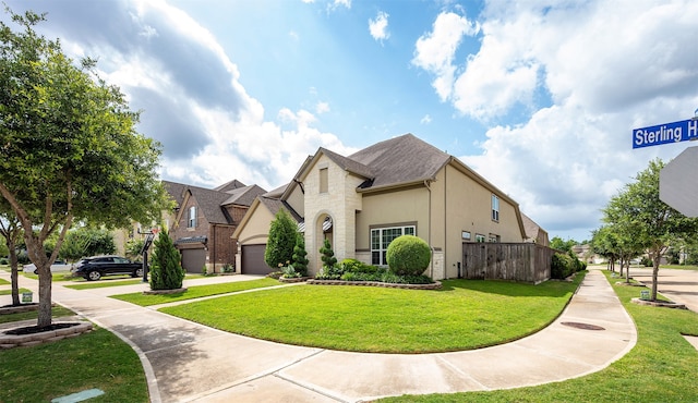 4423 Sterling Heights Ln, Sugar Land, TX 77479 - view of front of property featuring stone siding, a garage, stucco siding, and driveway