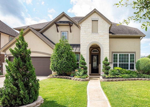 4423 Sterling Heights Ln, Sugar Land, TX 77479 - french country home with stucco siding, a front lawn, stone siding, and an attached garage