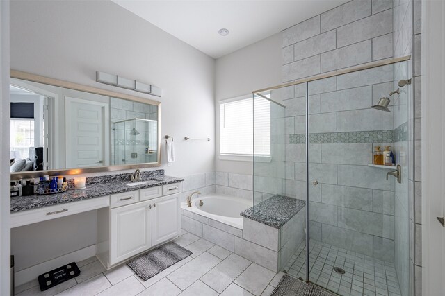 4423 Sterling Heights Ln, Sugar Land, TX 77479 - bathroom with tile patterned floors, a garden tub, a stall shower, and vanity