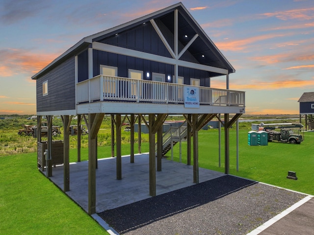 1025 Sunset Cir W, Crystal Beach, TX 77650 - view of home's community featuring a carport, driveway, a yard, a patio area, and stairs
