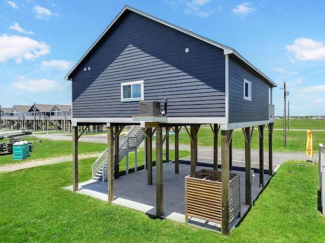 1025 Sunset Cir W, Crystal Beach, TX 77650 - view of property's community with a patio area, a yard, and stairway